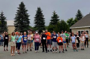 5K participants at start line waving at camera